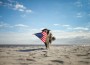 Patriotic,Border,Collie,Dog,Running,Along,The,Beach,Carrying,The