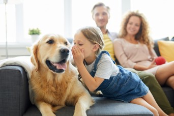 Little,Girl,Whispering,Something,To,Her,Pet,While,Relaxing,On
